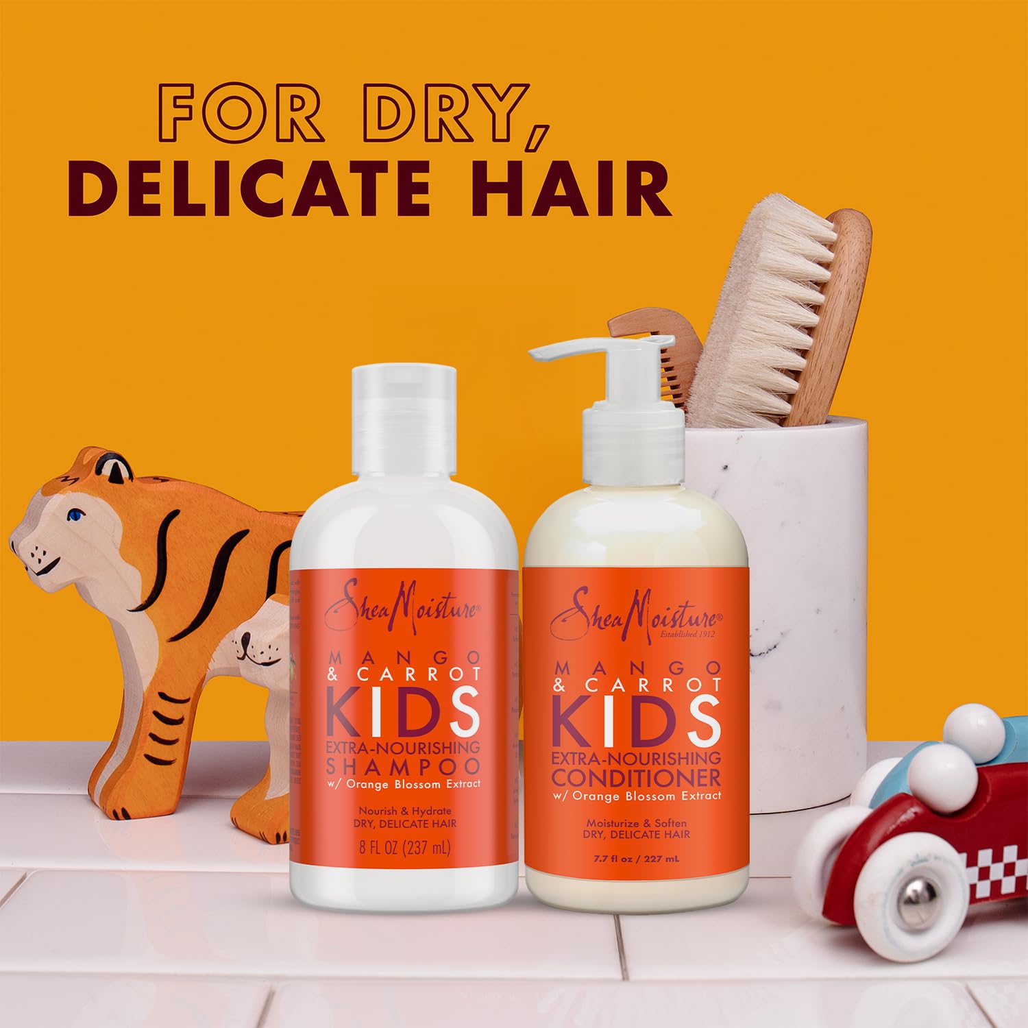 SheaMoisture Coconut Hibiscus Detangler Spray bottle helps smooth knots for easier brushing.
