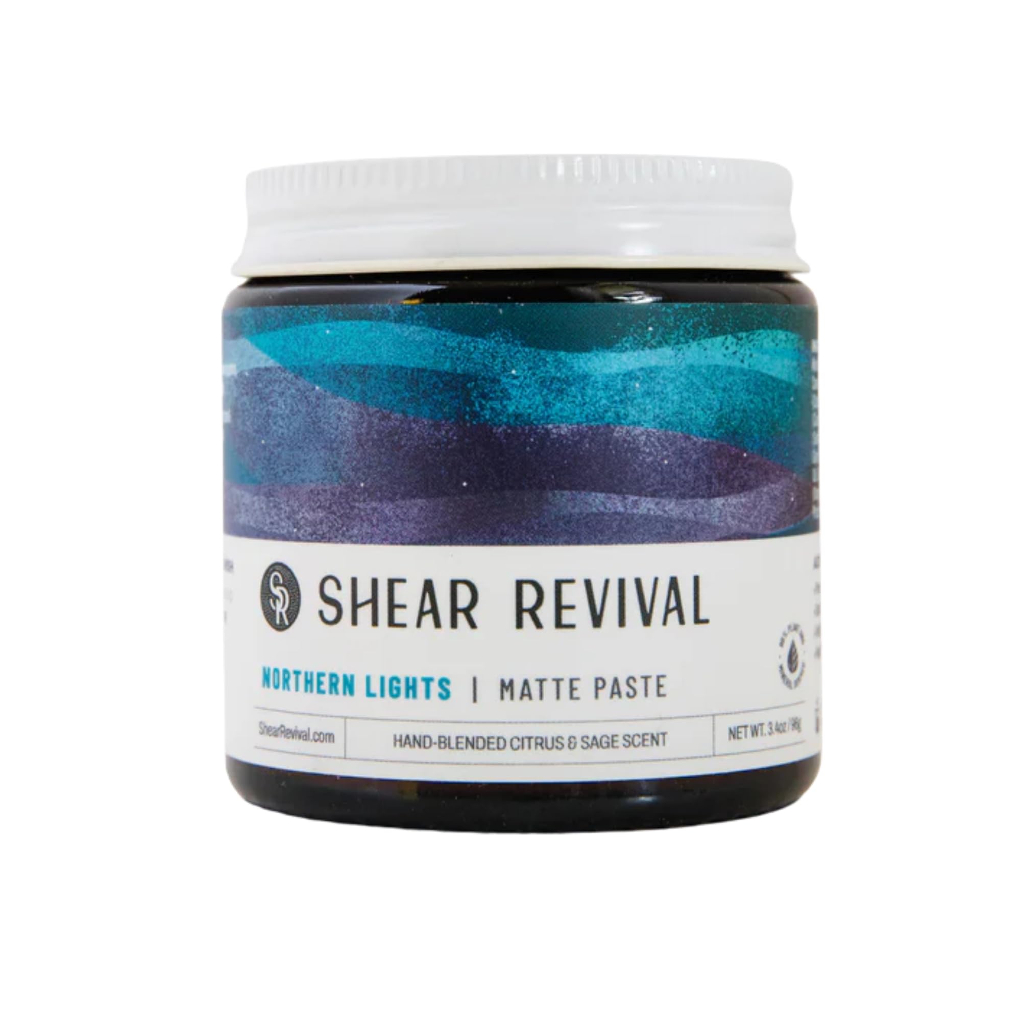 Shear Revival Northern Lights matte paste jar in amber glass for travel-friendly, reusable packaging.