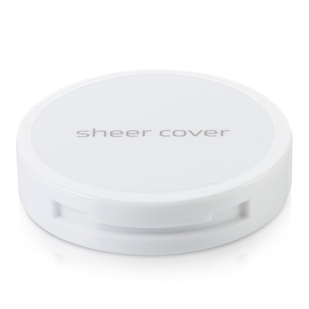 Sheer Cover Studio open compact with brush for quick on-the-go touch-ups.