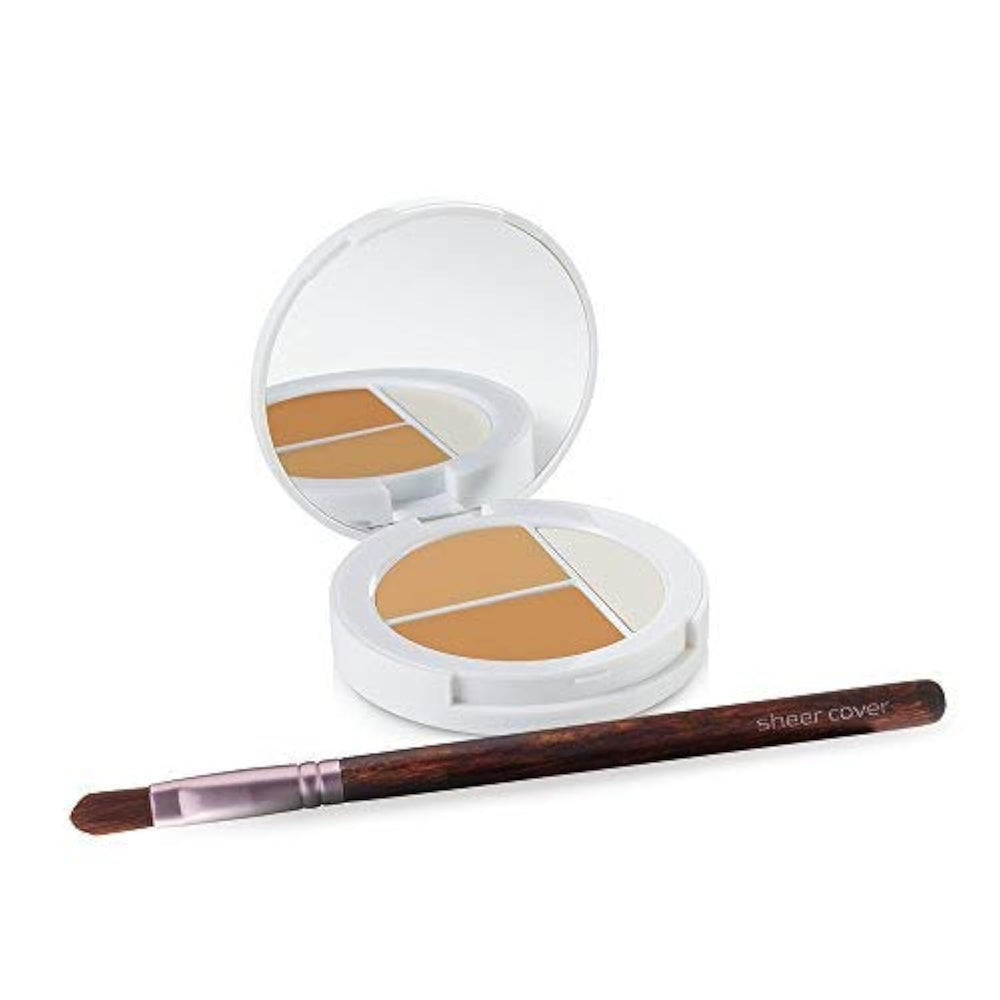 Sheer Cover Studio compact close-up shows two concealers blending for natural coverage.