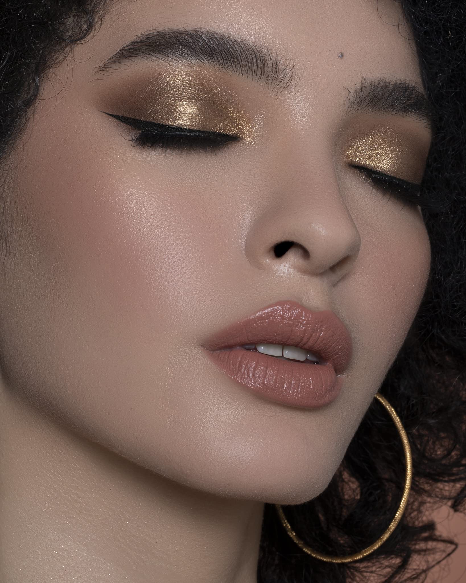 Sigma Beauty E38 professional-use brush shown in a studio setting.