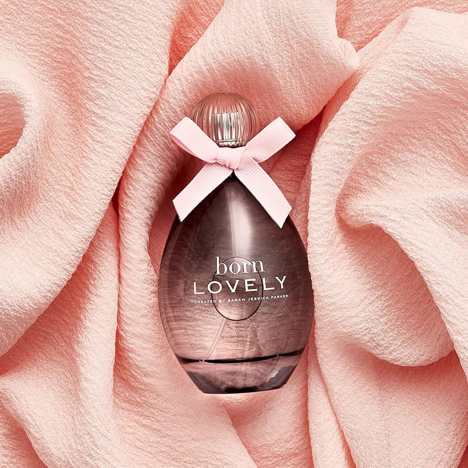 SJP Born Lovely amber-floral bottle closeup suggesting inviting everyday radiance.