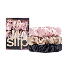 SLIP large scrunchie multi pink closeup: smooth silk reduces friction for gentler hair wear.