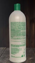 SOF N' FREE hands applying curl activator for smooth distribution.