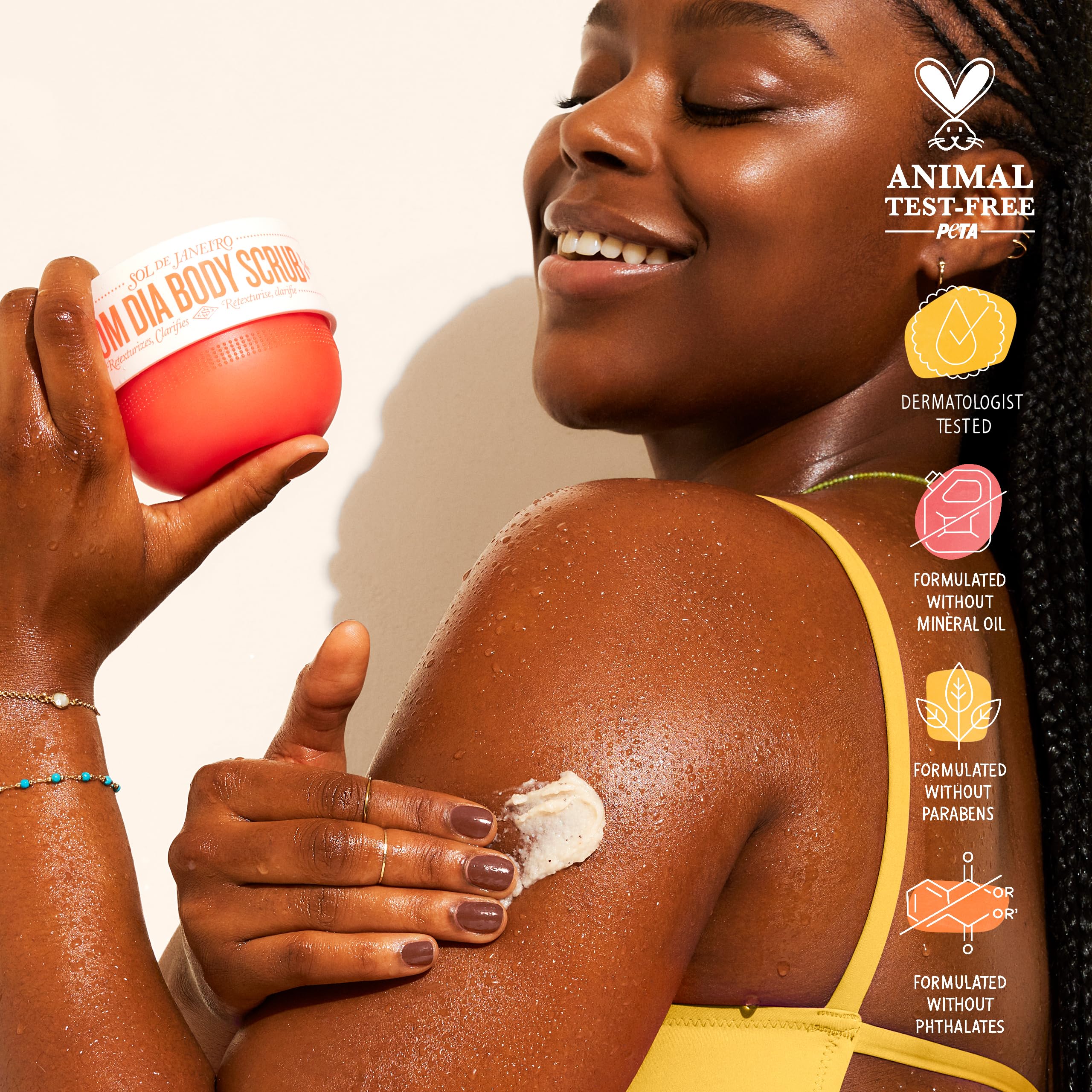 Sol de Janeiro Bom Dia Bright Body Scrub hands applying to arm for texture improvement