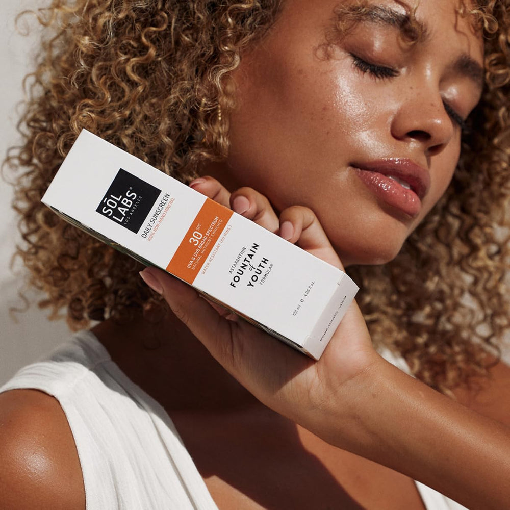 SOL LABS sunscreen on beach backdrop conveys outdoor sun defense
