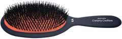 Spornette boar bristle brush large cushion-oval in hand smoothing hair with gentle pressure
