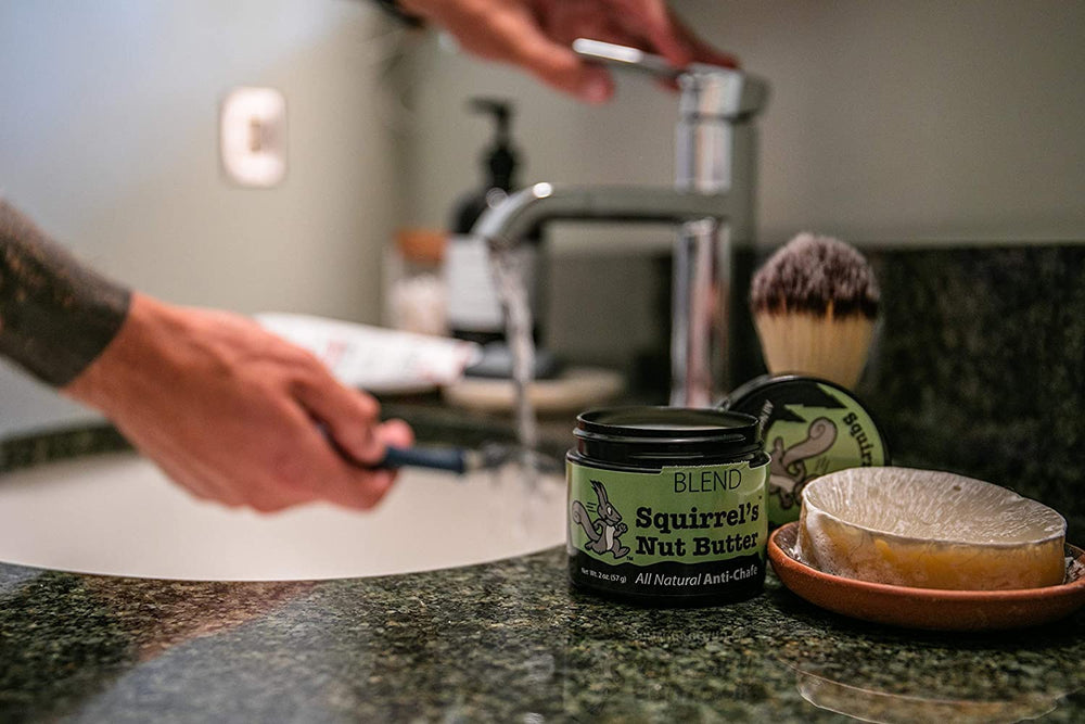 Squirrel's Nut Butter athlete applying salve on thigh before activity for comfort