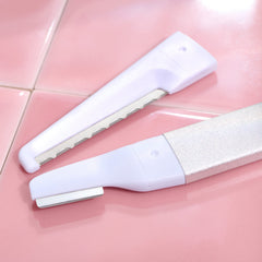 StackedSkincare dermaplaning blades 3-pack on counter ready for smoother makeup application.