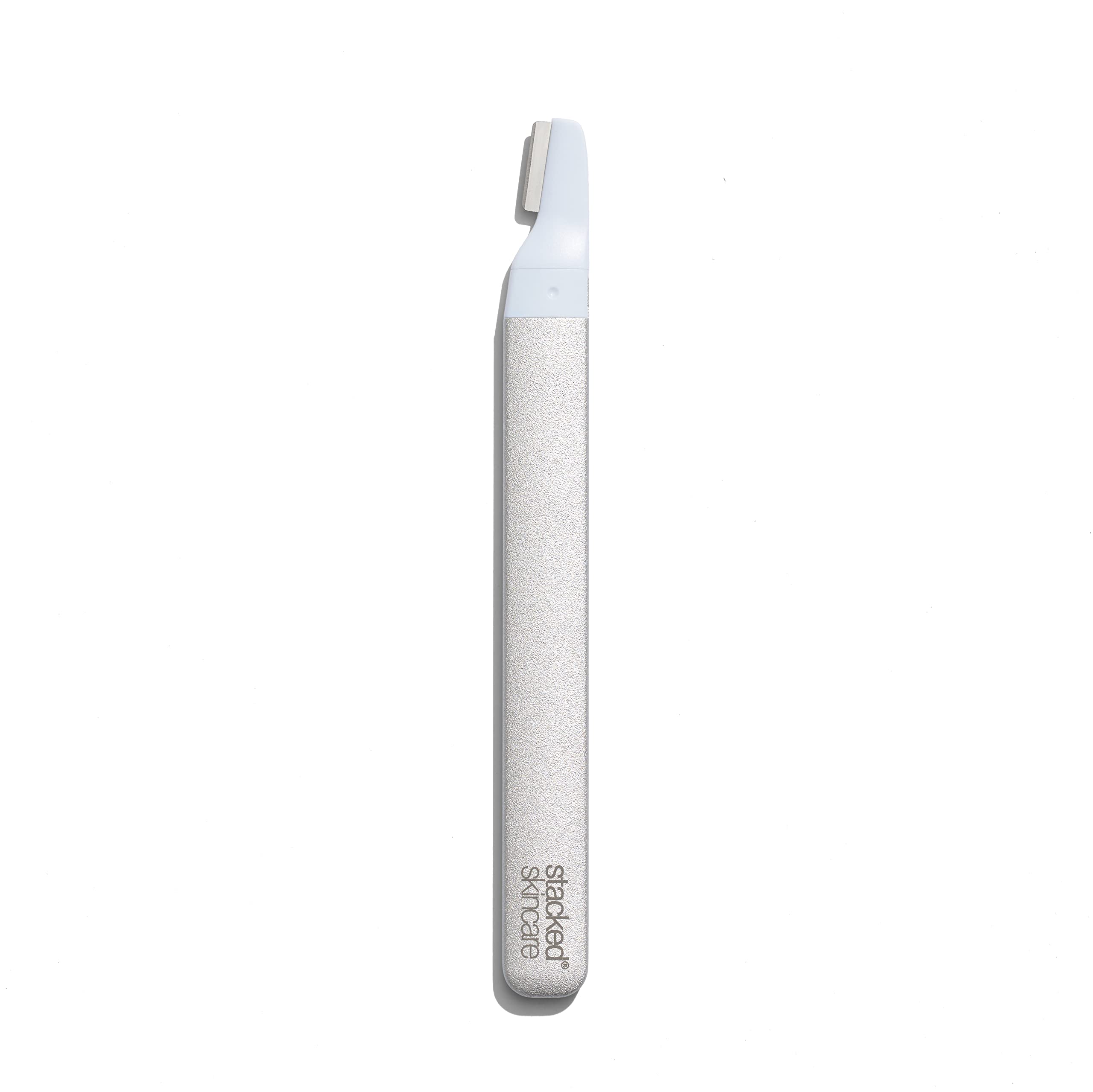 StackedSkincare dermaplaning tool refill in hand for quick, hygienic blade replacement.