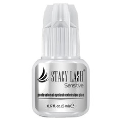STACY LASH Sensitive adhesive bottle closeup highlighting low fumes for sensitive eyes.