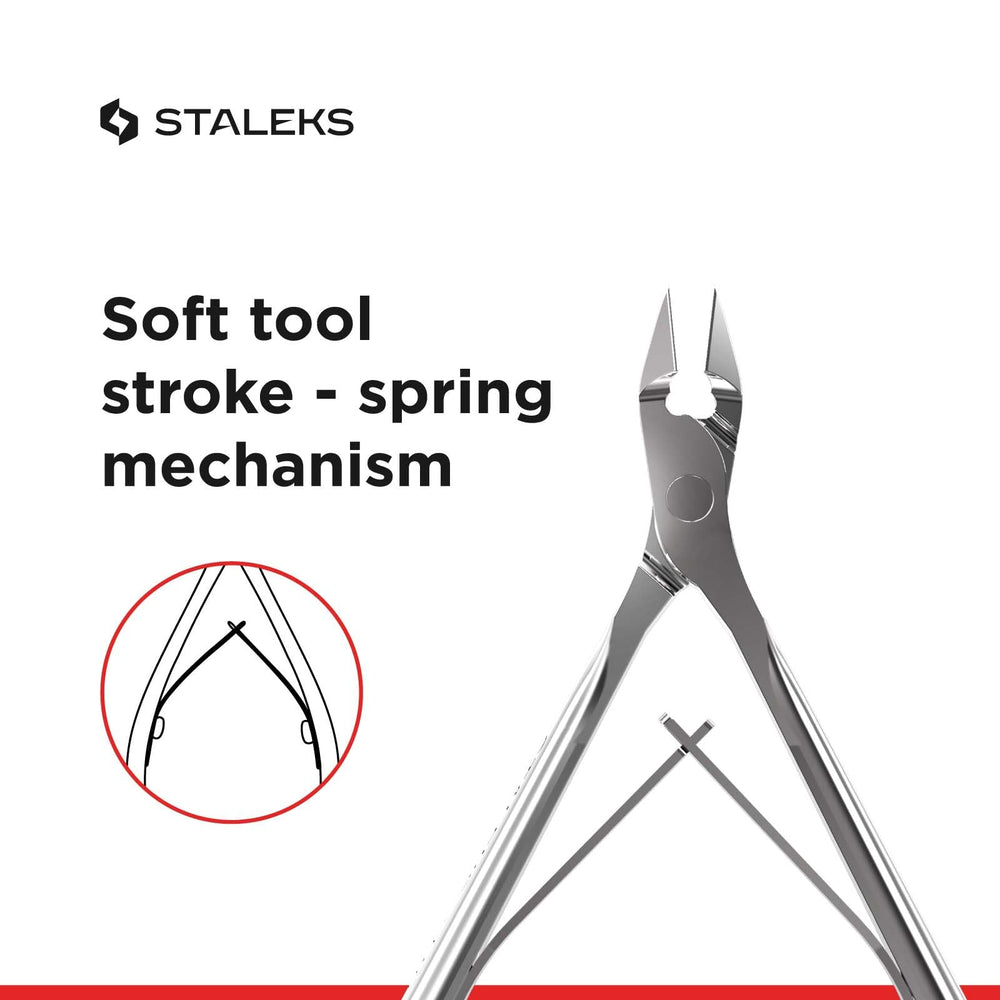 Staleks nippers on a clean manicure surface demonstrating precise trimming capability.