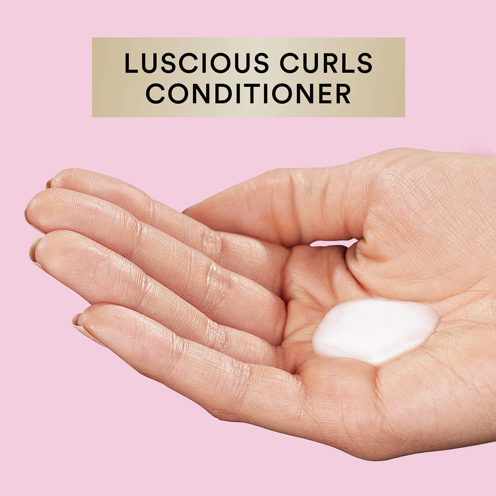 Suave Luscious Curls Conditioner creates soft, touchable curls.