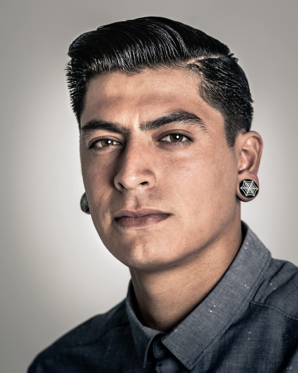 Suavecito oil based pomade close-up hair with high shine.