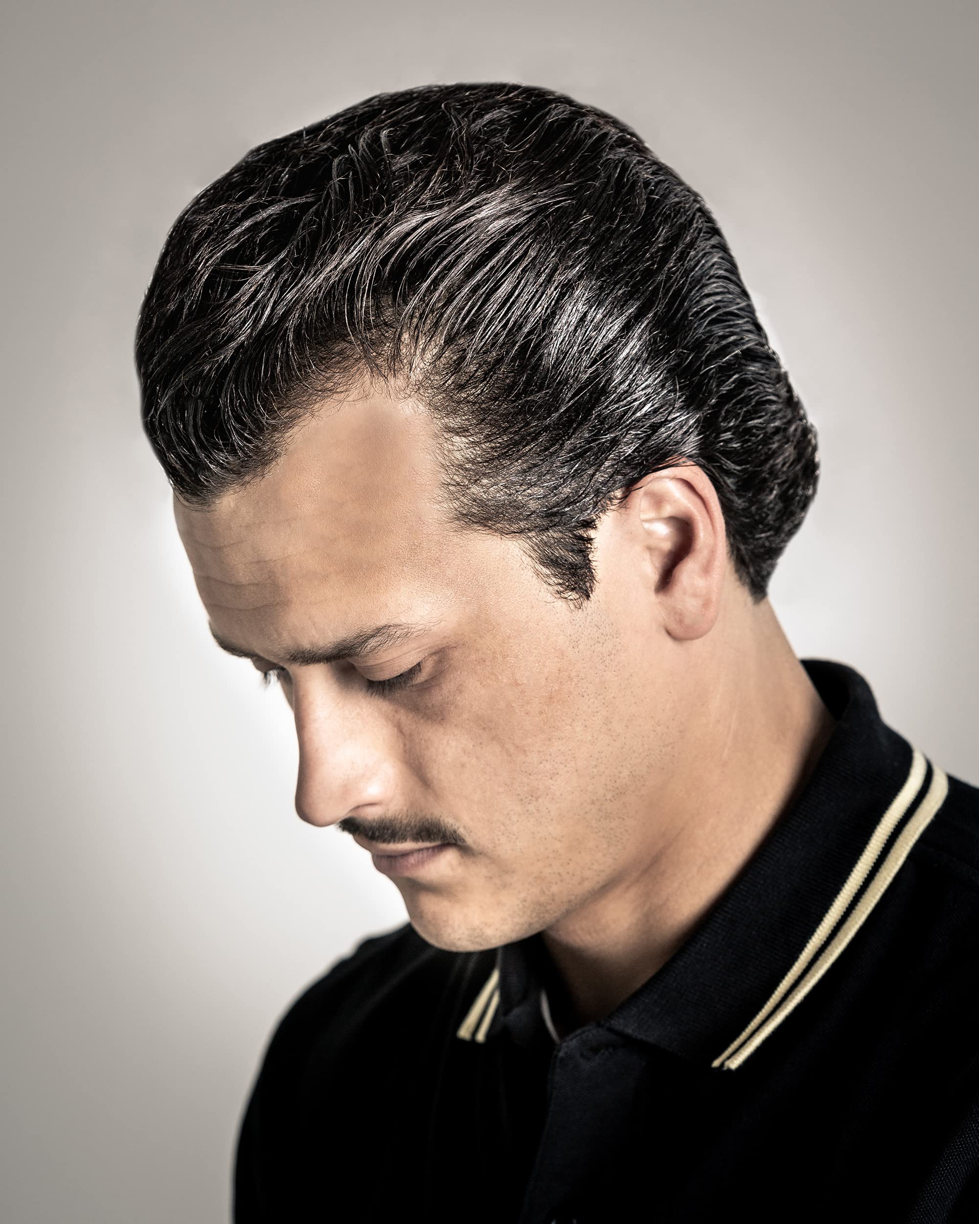 Suavecito oil based pomade enabling rockabilly pompadour and quiff.