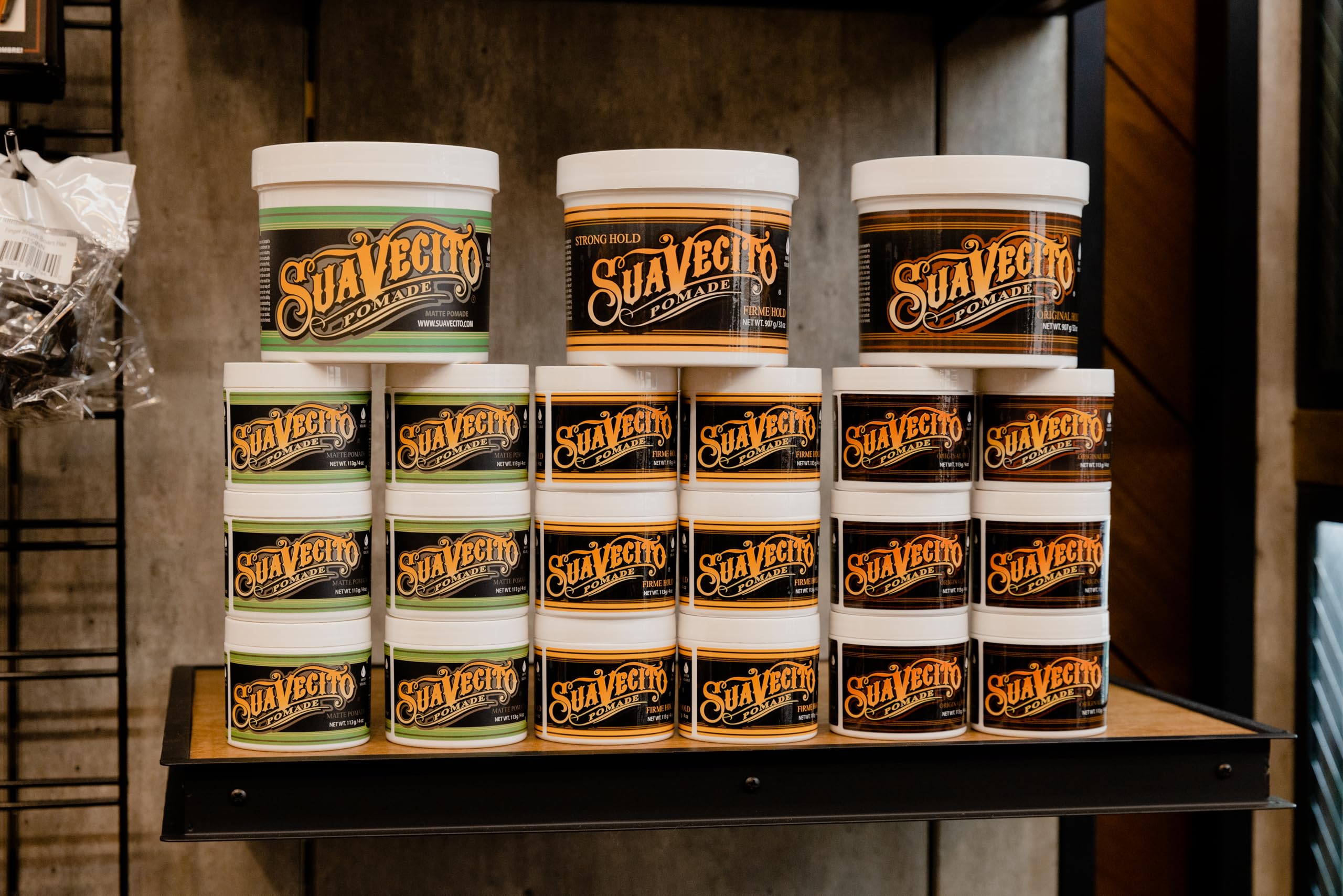 Suavecito Original Hold Pomade 32oz tub washout image emphasizes easy water cleansing