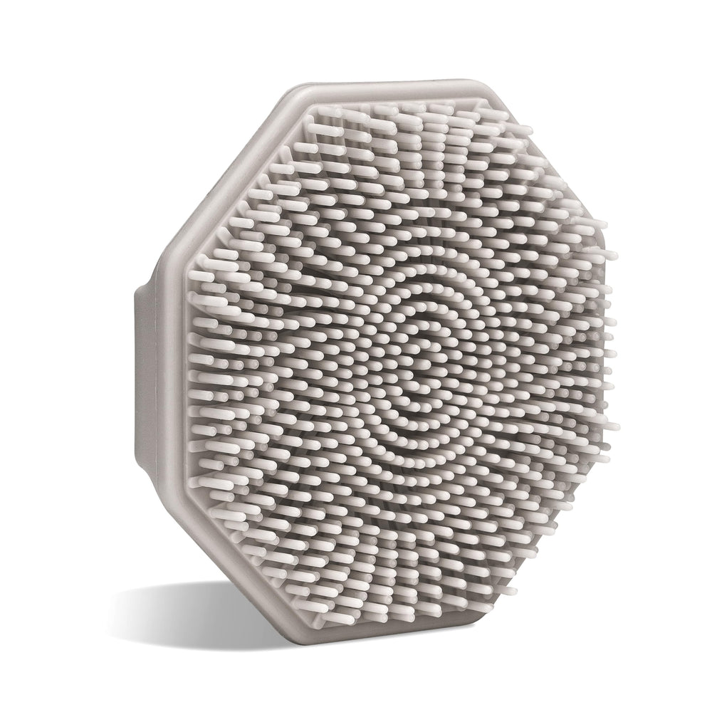 Sud Scrub antimicrobial silicone face scrubber held in hand for precise, gentle cleansing