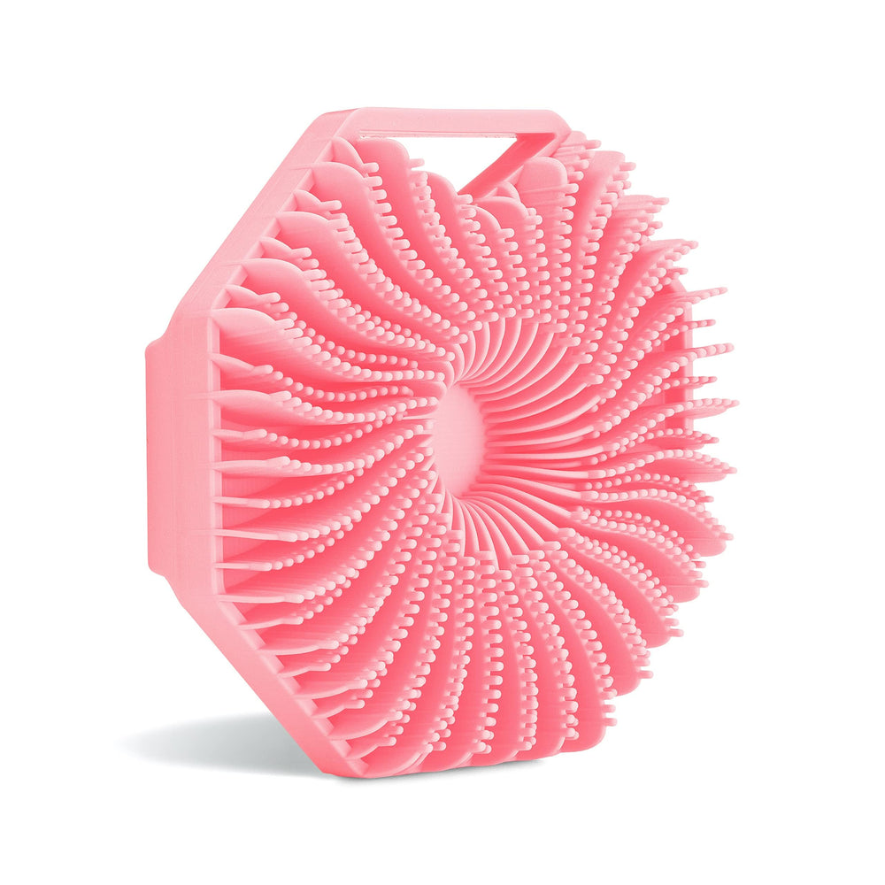Sud Scrub antimicrobial silicone body scrubber in pink cleanses gently while reducing odor-causing microbes.