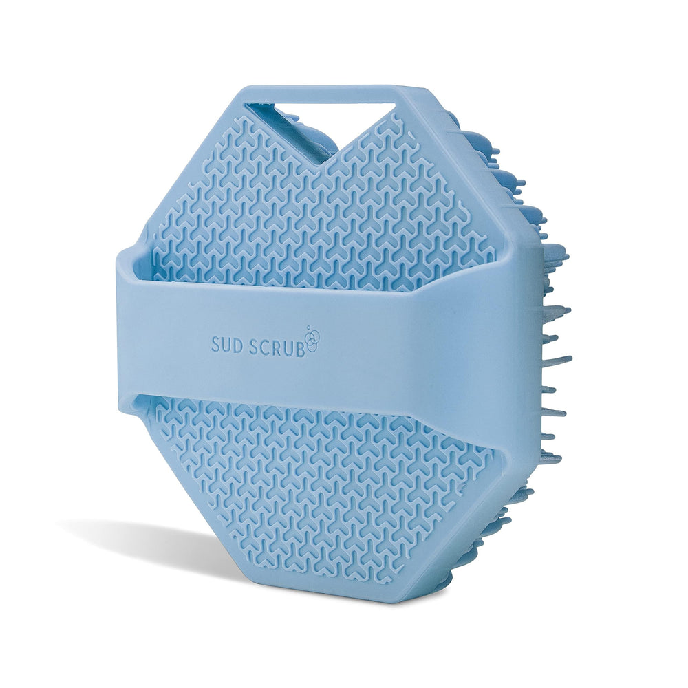 Sud Scrub blue body brush in use for quick exfoliation and cleansing