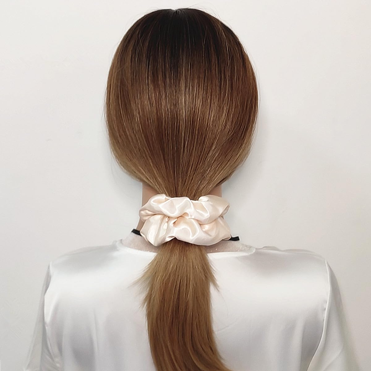 Sufermoe beige satin silk scrunchies worn in a ponytail for smooth hold