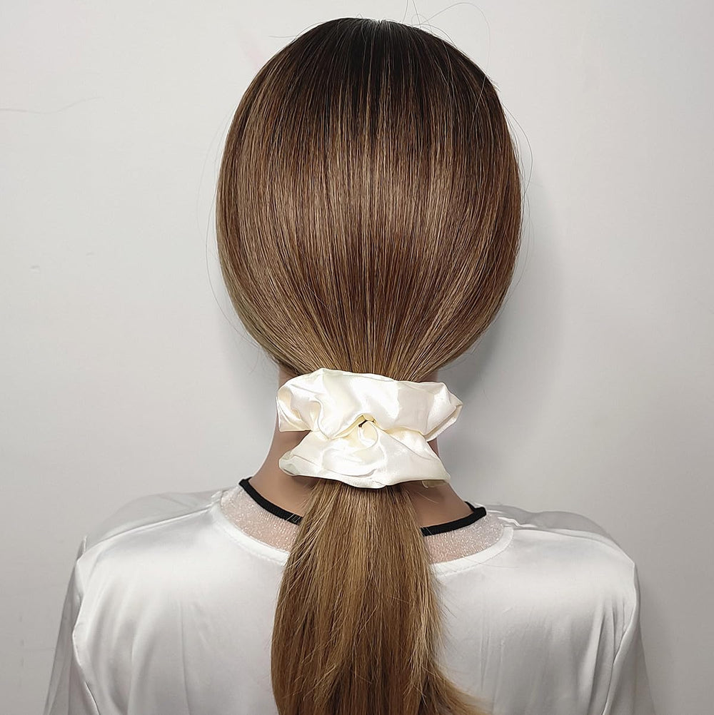 Close-up of Sufermoe satin silk scrunchies showing soft texture and gloss.