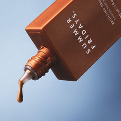 Summer Fridays Bronzing Drops applied with makeup for a dewy bronze finish.