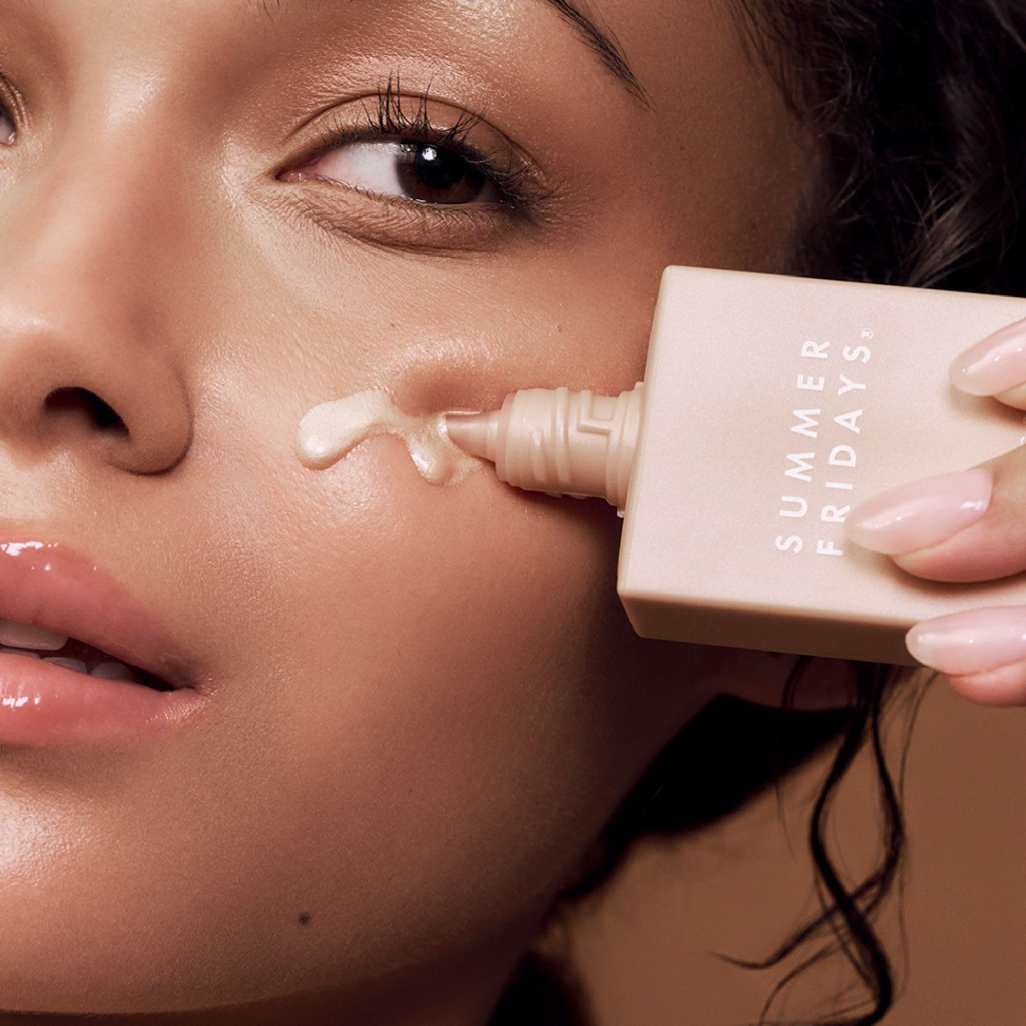 Summer Fridays Illuminating Drops applied to cheek for glass skin radiance