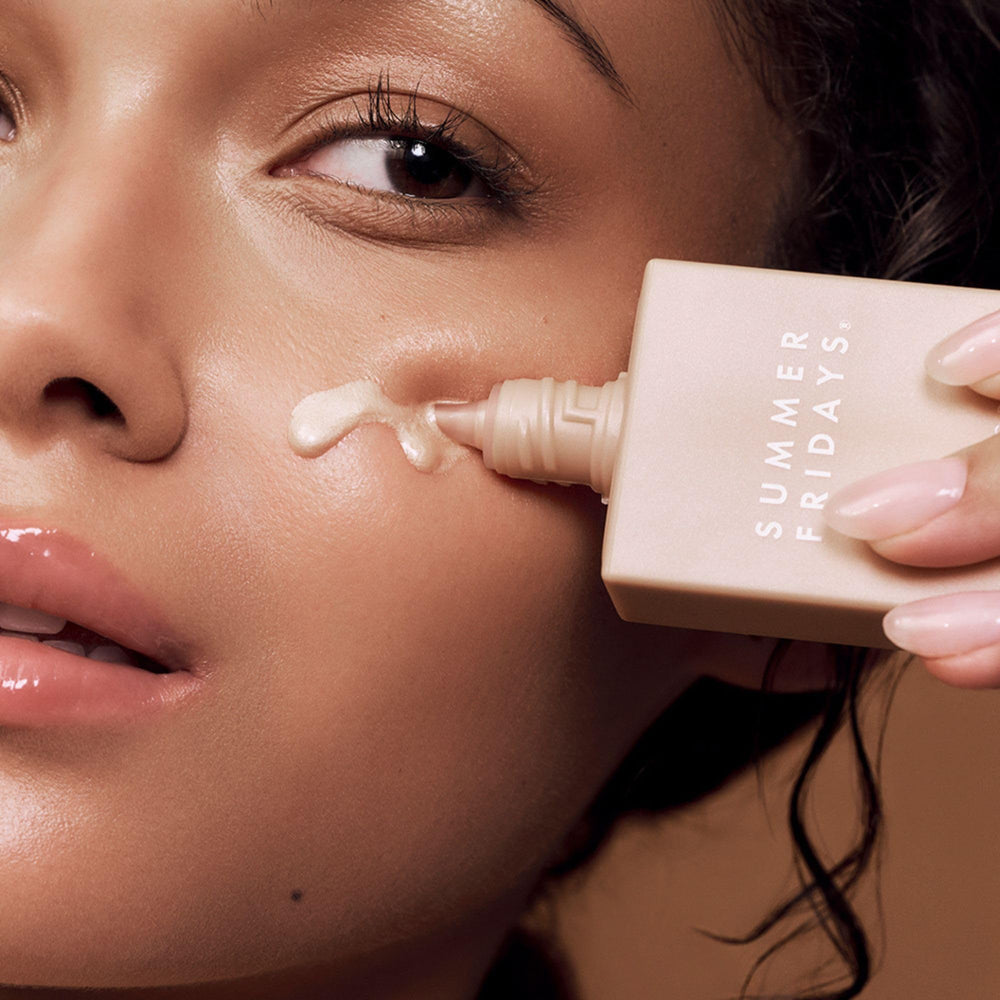 Summer Fridays Illuminating Drops applied to cheek for glass skin radiance