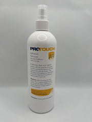 Sunshine Tape Pro Touch Adhesive Remover being applied to hairpiece for easy cleanup.
