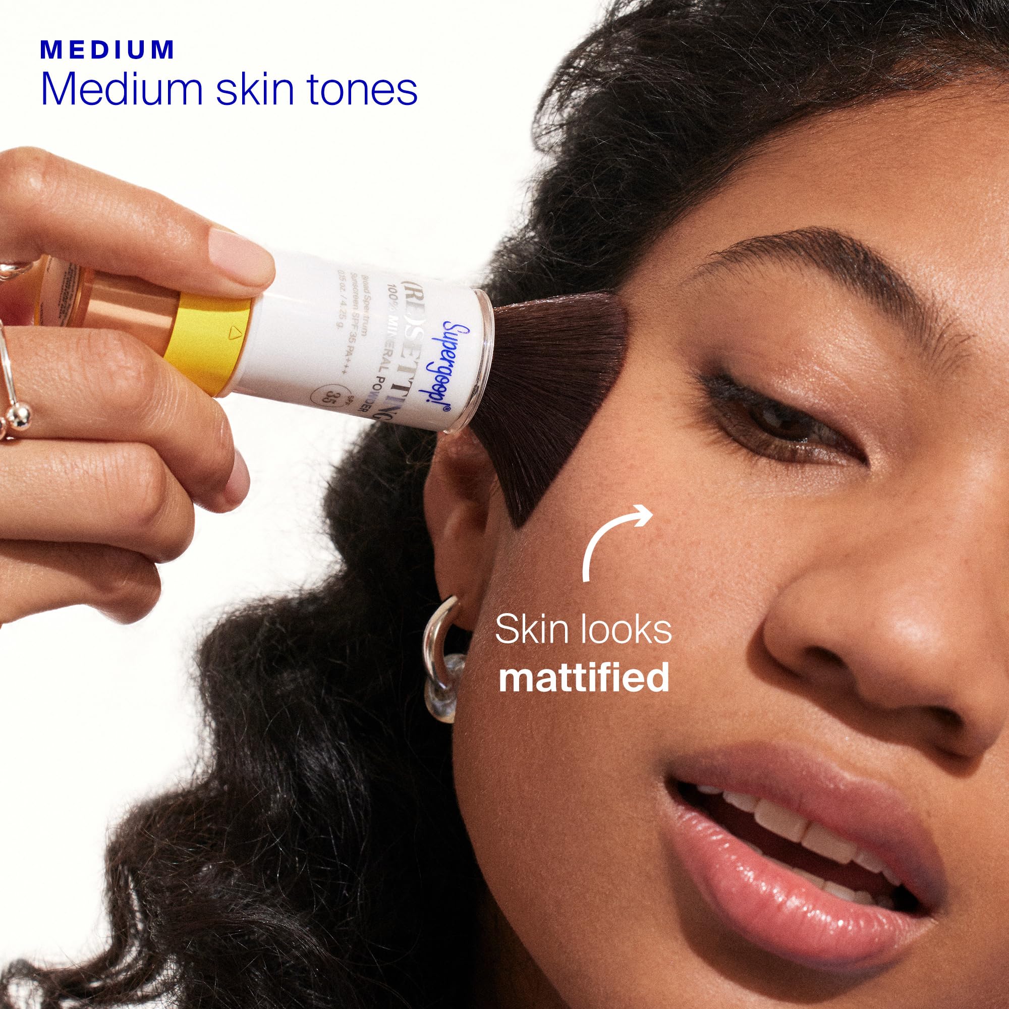 Supergoop! (Re)setting Powder applied over makeup for reapplication and UV protection refresh