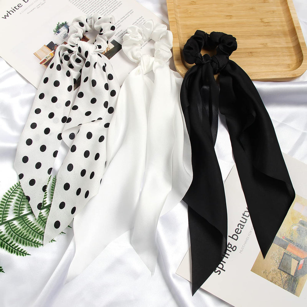 SUSULU scrunchie worn on a handbag adds a subtle color accent.