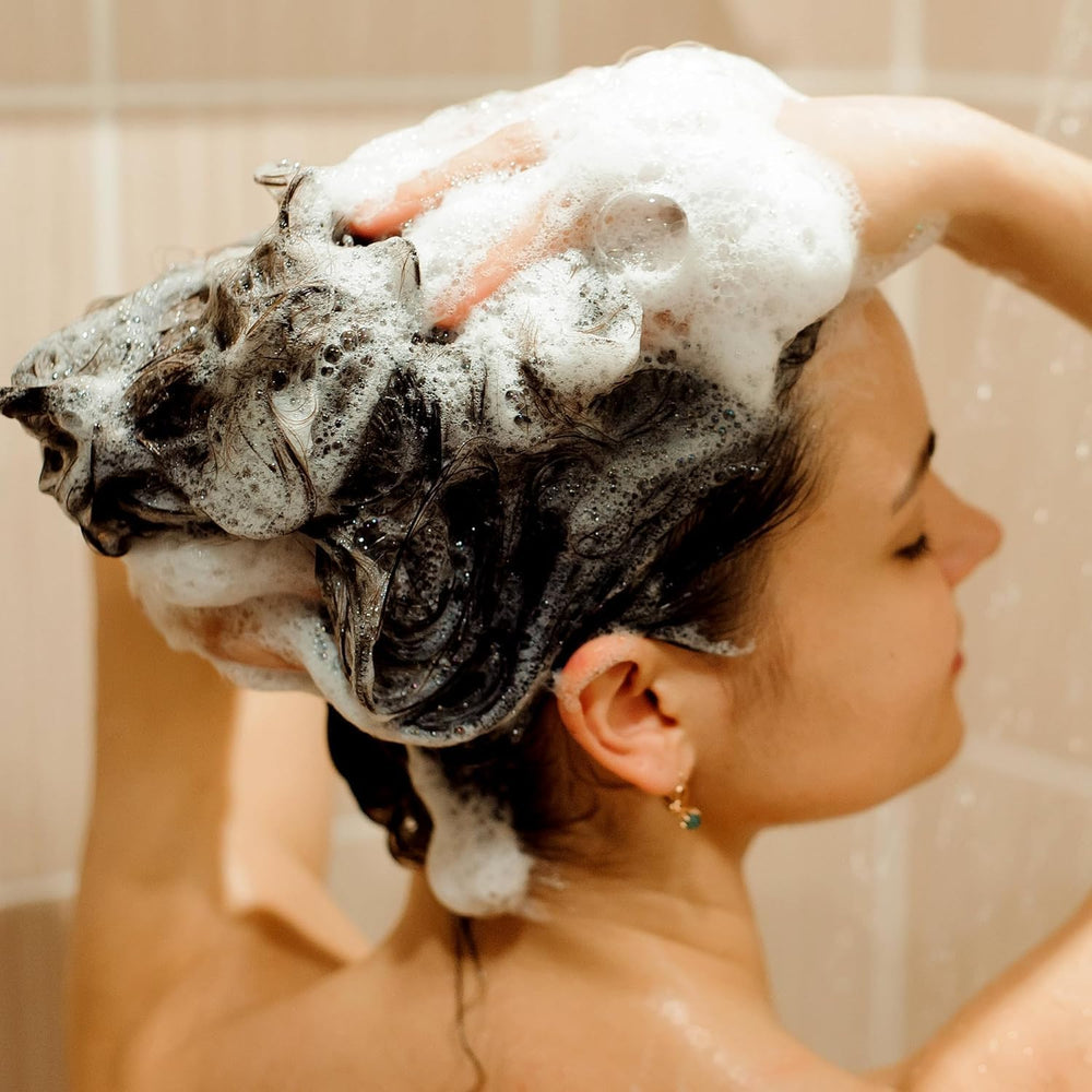 Svvimer hands applying shampoo to scalp demonstrates easy massage technique.