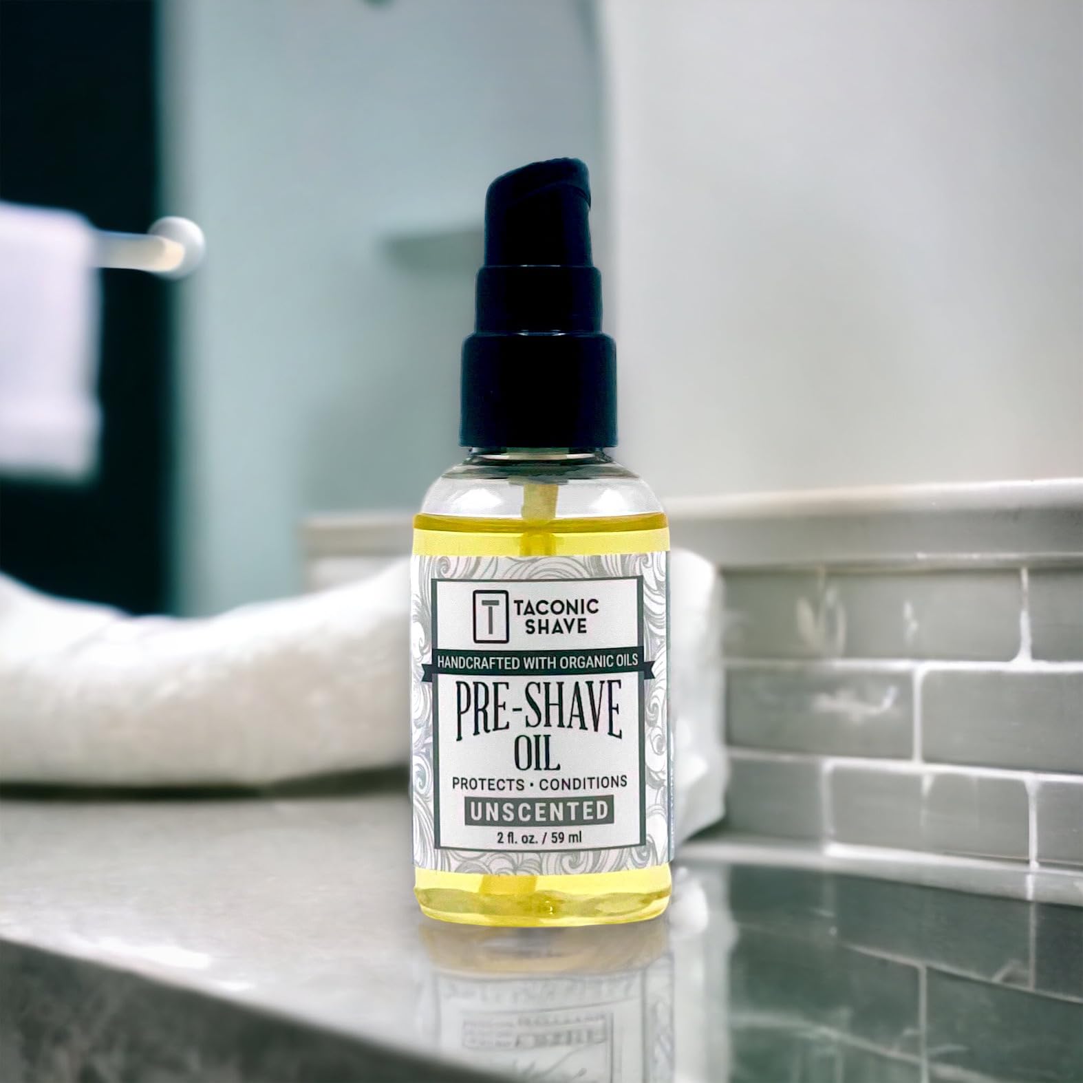 Taconic Shave apply-beard shot demonstrates massaging oil before shaving.
