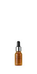 Tan-Luxe The Body Illuminating Drops bottle close-up illustrating vegan self-tanner for natural glow