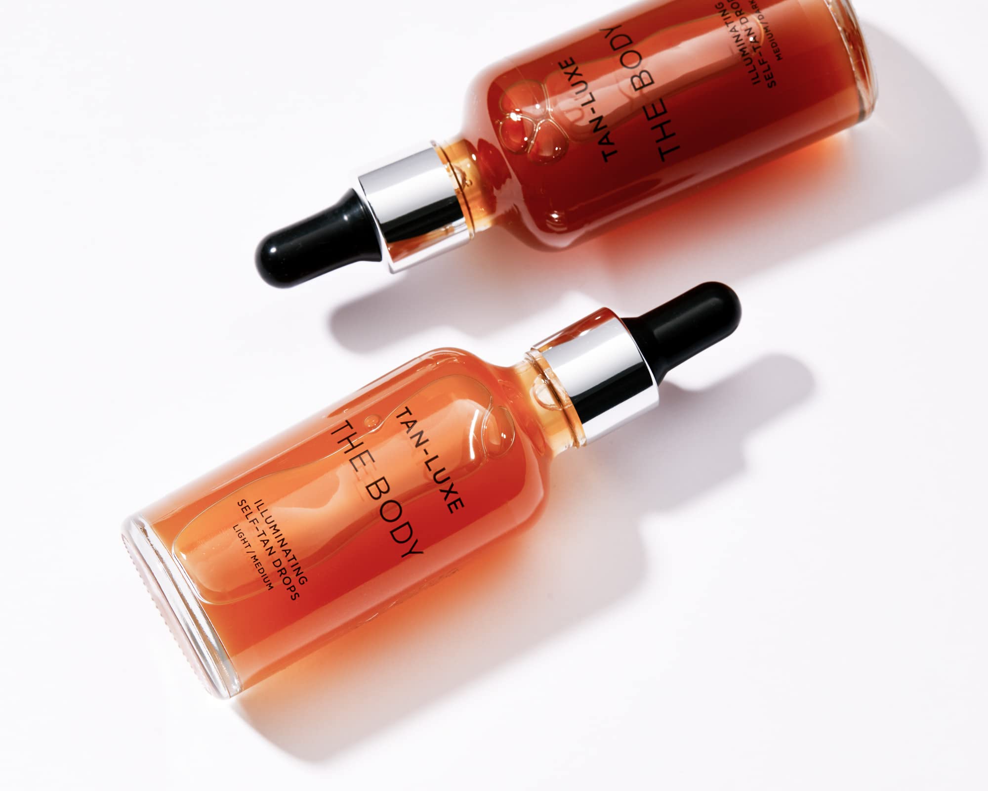 Tan-Luxe Body Illuminating Drops packaging emphasizing vegan, cruelty-free formula