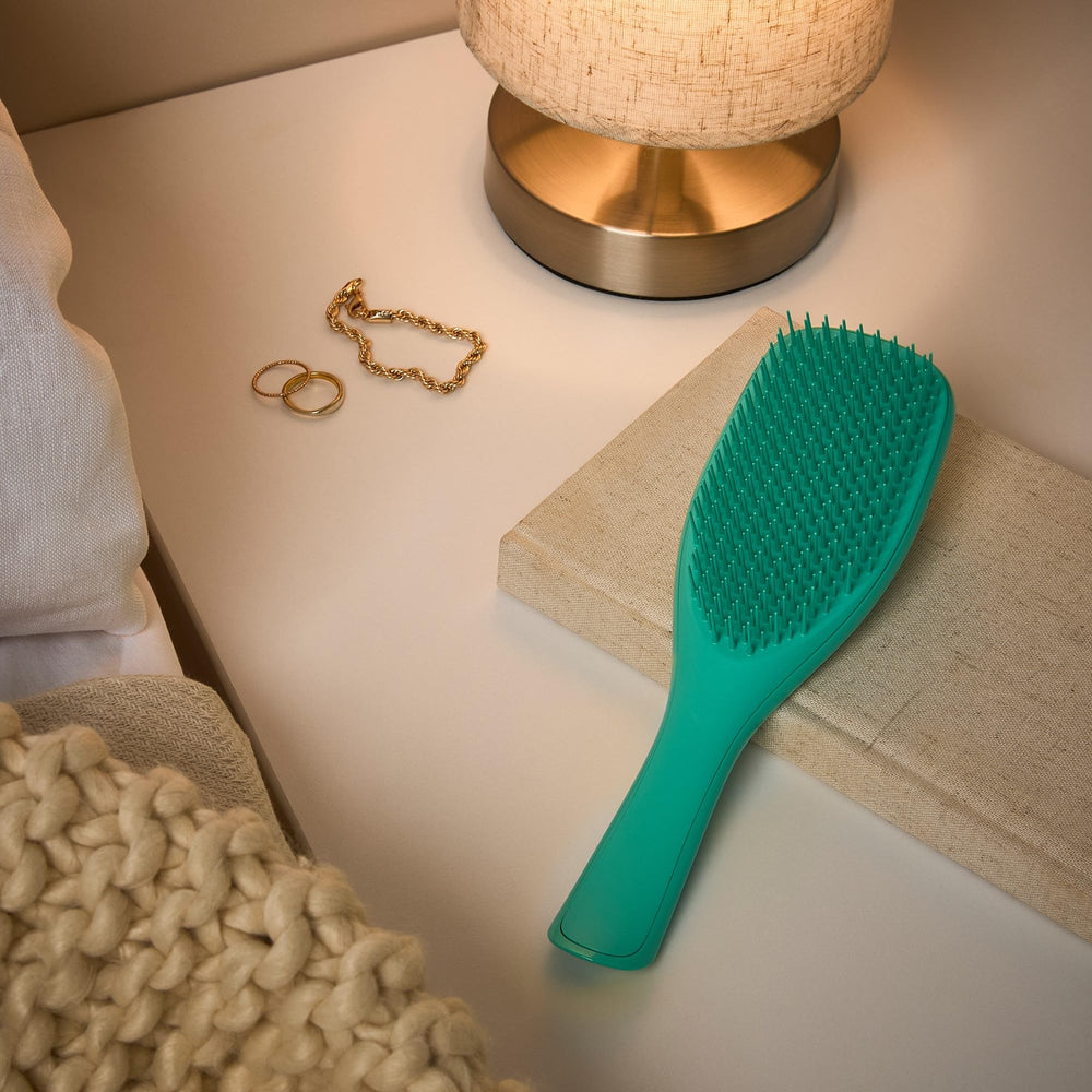 Bathroom setup with aqua green Tangle Teezer ready to glide through hair