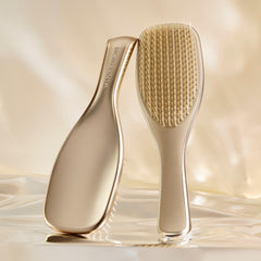 Tangle Teezer Chrome detangling teeth close-up showing two-tier design for knot removal and cuticle smoothing.