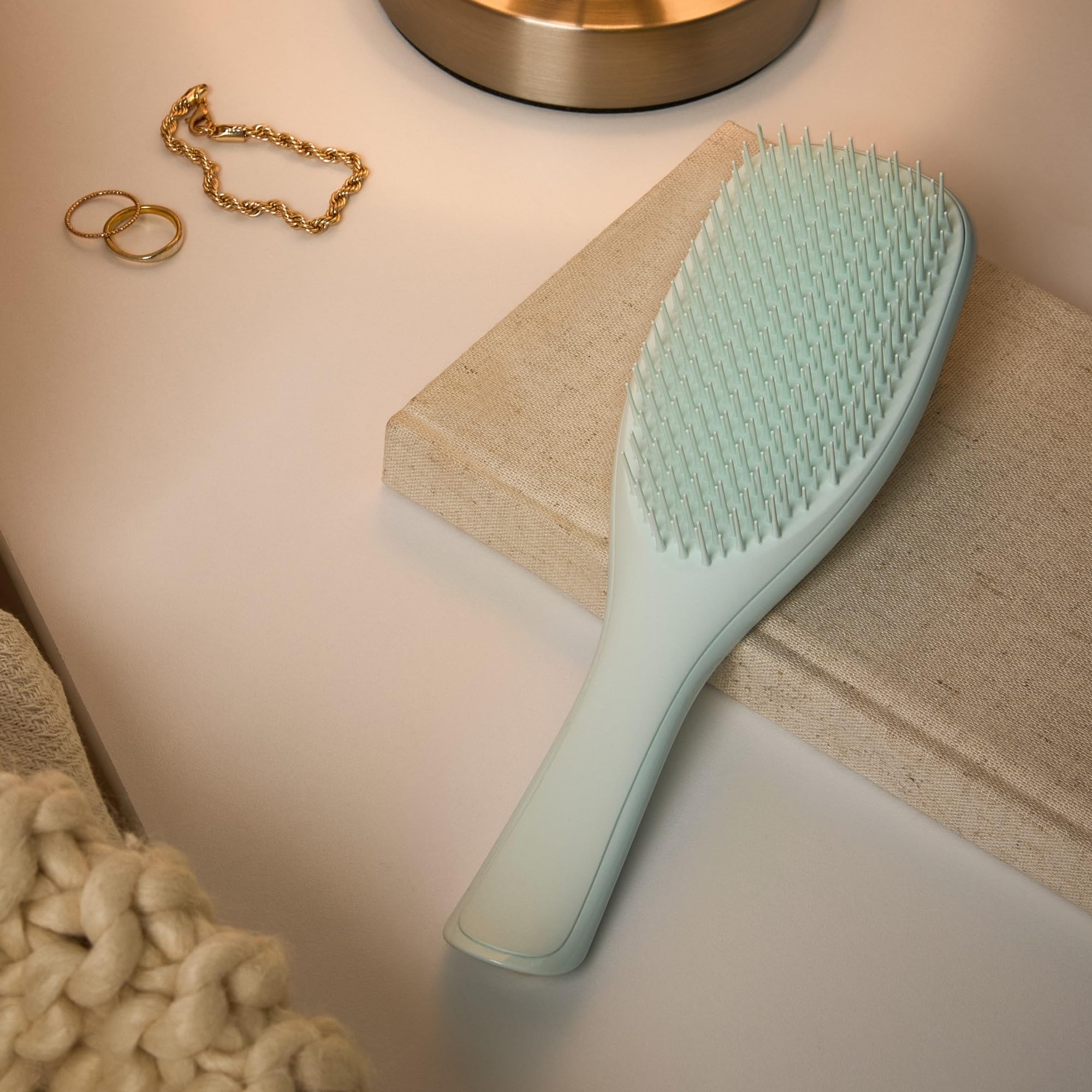 Tangle Teezer ice blue brush on damp hair for smoother, manageable locks.