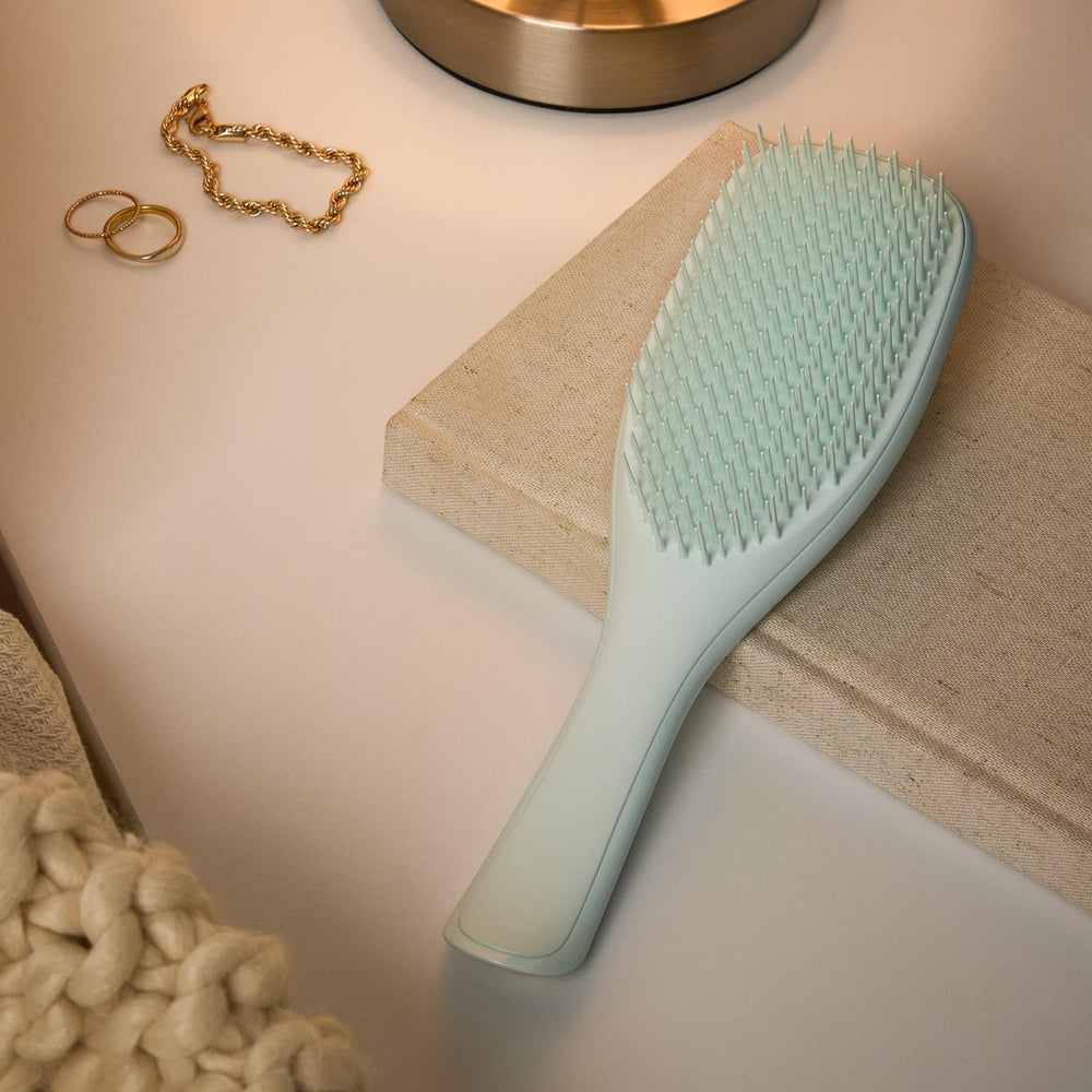 Tangle Teezer ice blue brush on damp hair for smoother, manageable locks.