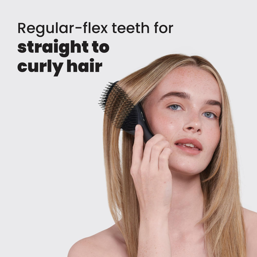 Tangle Teezer Ultimate Detangler in liquorice black smoothing wet-to-dry hair for frizz control.