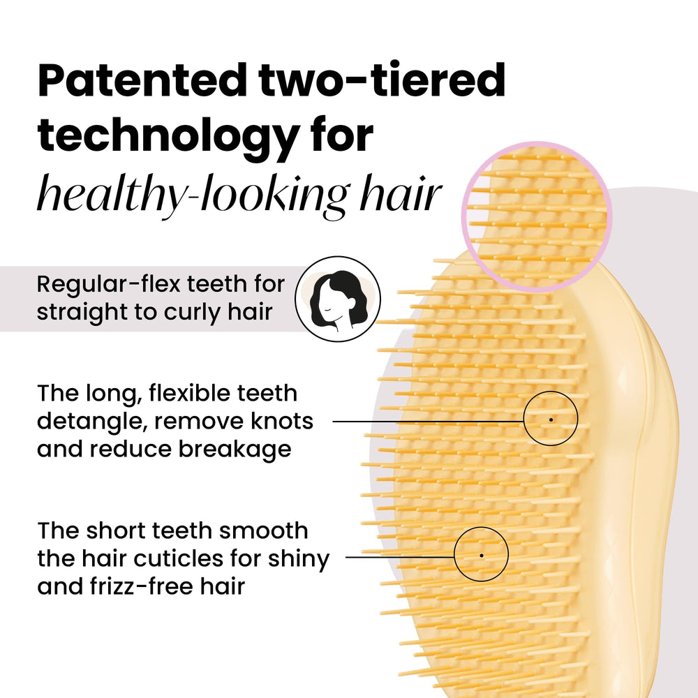 Tangle Teezer Original Detangler Buttercup Yellow in hand showing ergonomic palm grip.