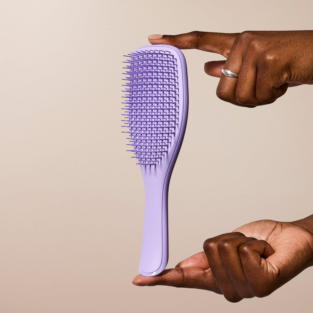 Tangle Teezer Ultimate Detangler travel-friendly design on vanity for easy on-the-go detangling