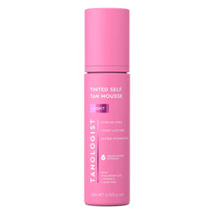 Tanologist Light Self Tan Mousse tube close-up with color guide for even application.