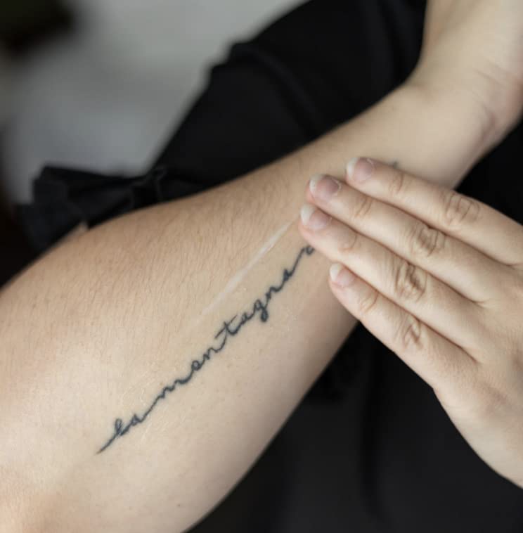 Tattoo Goo balm application on skin demonstrates soothing aftercare for fresh tattoos