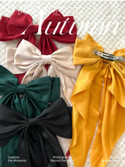TERSE DTERSE long tails satin bow adds dramatic flair to looks