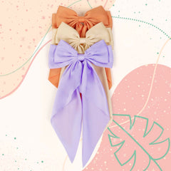 TERSE durable metal barrettes secure the oversized bow throughout the day