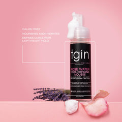 tgin Rose Water Defining Mousse being applied to curly hair for defined definition