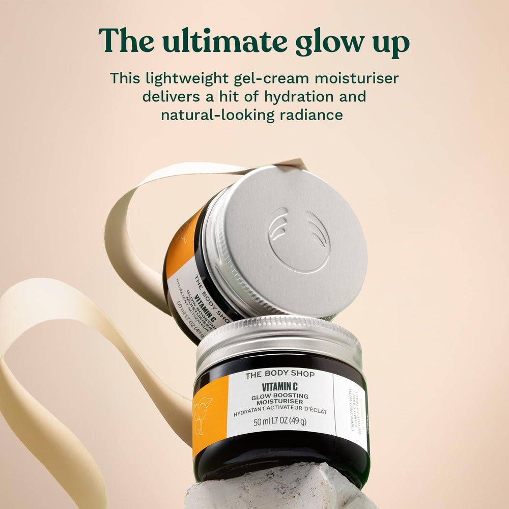 The Body Shop Glow Boost Moisturizer in hand ready for daily hydration.