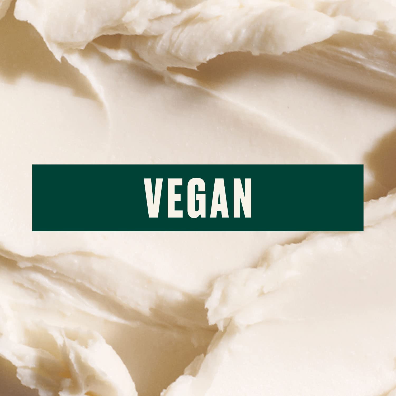 The Body Shop Almond Milk Body Butter jar closeup displaying creamy texture for dry skin.