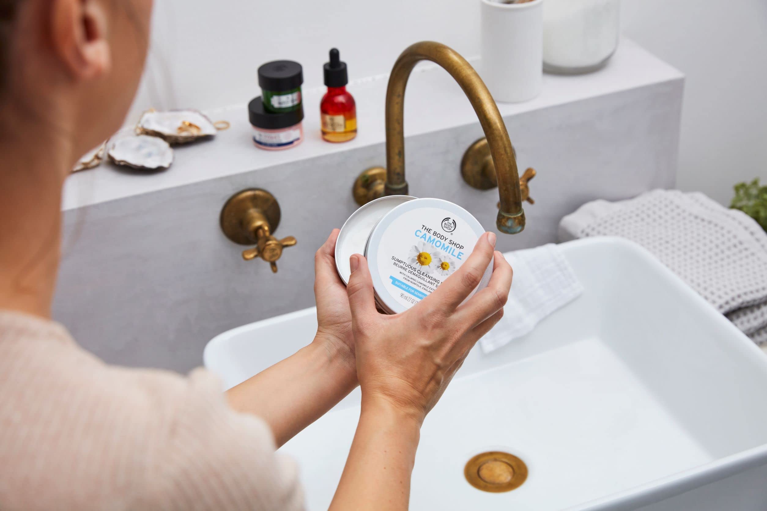 The Body Shop Camomile Sumptuous Cleansing Butter melting makeup on skin for a soft cleanse.